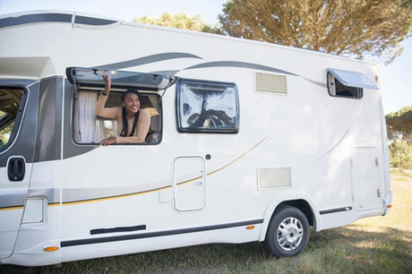 Lady looking out of the window of a campervan