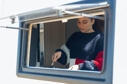 Lady at a caravan window
