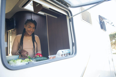 Lady looking out of a caravan or campervan window