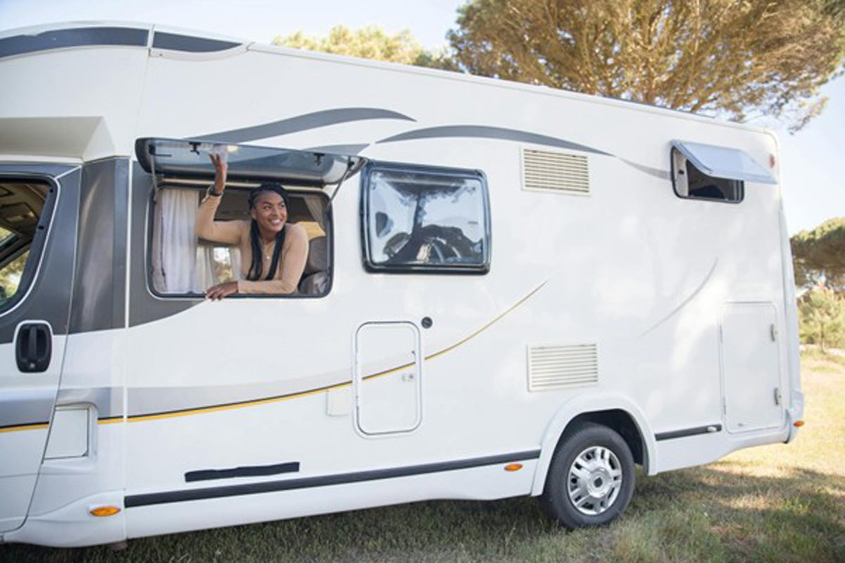 Lady looking out of the window of a campervan